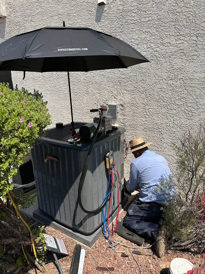 HVAC technician performing outdoor AC maintenance in Southside